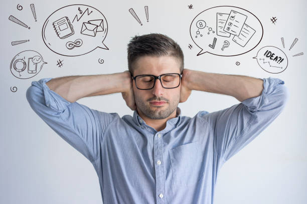 istock Manager trying to concentrate with hand drawn business sketches 1211765996