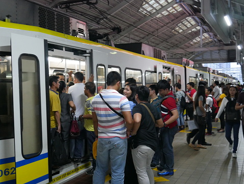 Manila, the Philippines-October 24, 2017: Crowded of commuters trying to get on the city train in Manila, the Philippines