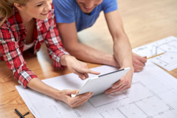 istock smiling couple looking at tablet pc at home 1211766959