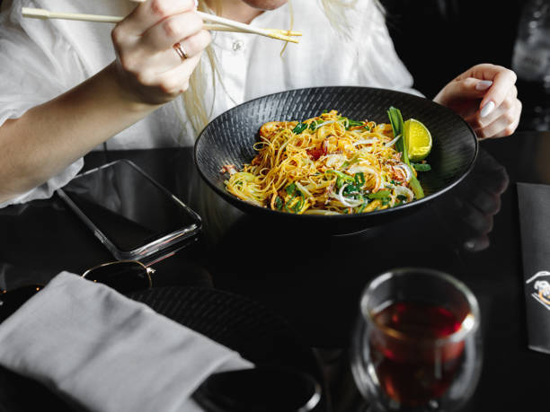 girl eats noodles with chopsticks