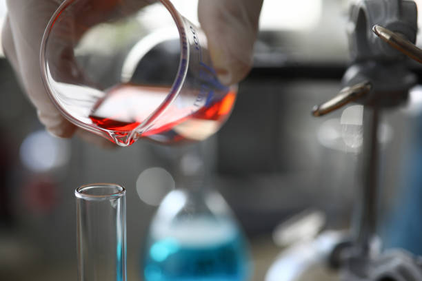 Red liquid in chemical pipette token from a laboratory flask