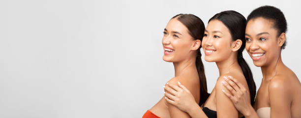 istock Three Attractive Girls In Bra Posing Over Gray Background, Panorama 1211775340