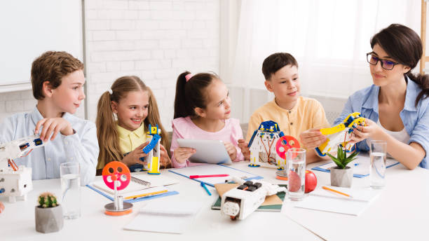 istock Modern technologies. Teacher showing children new robot 1211776143