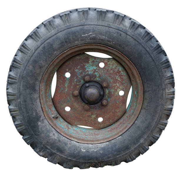 istock Old rusty big  aged wheel from a vintage agricultural  tractor isolated 1211776150