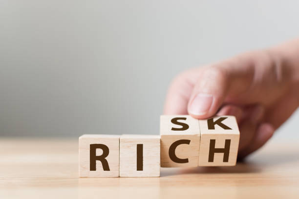 istock Risk or Rich concept, Hand flip wood cube change the word 1211776158