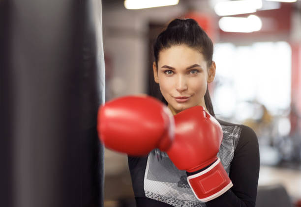 istock Personal defense class. Young female boxer in gym 1211776287