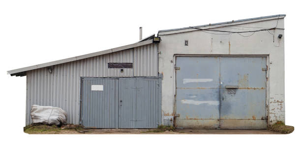 The collapsing usual old narrow shed of plastered  bricks  and metal sheets walls  for sale.  Isolated stock photo