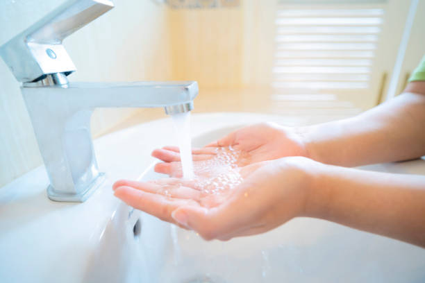 istock woman washing hands 1211777925