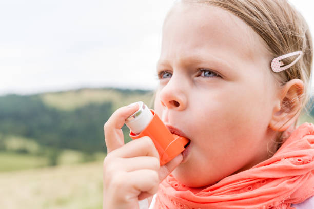istock Girl having asthma using asthma inhaler for being healthy 1211781740