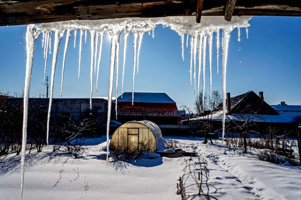istock icicles hanging from the roof illuminated by the midday sun 1211782652