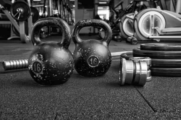 istock Dumbbells and kettlebells on a floor. 1211783557