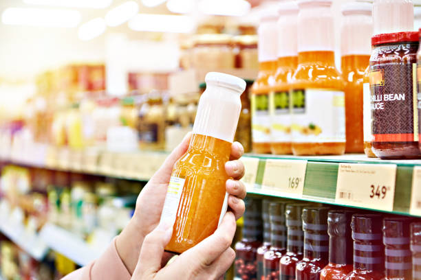 istock Culinary sauce in hand buyer at store 1211784391