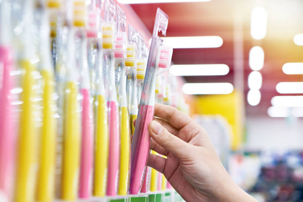 istock Toothbrush in package in hand in store 1211784742