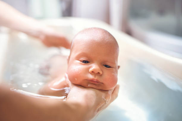 istock Hands of a careful unknown mother hold boy 1211784992