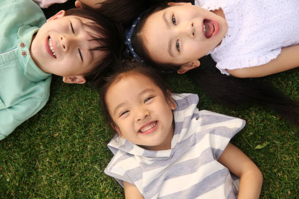 istock Happy children play on the grass 1211787930
