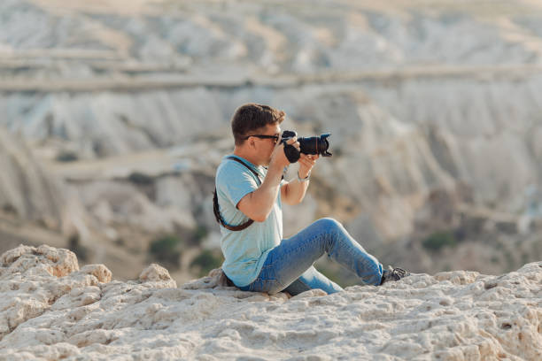 istock a photographer sits on rock in Cappadocia 1211788247