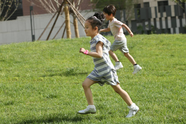 istock Children are playing on the grass 1211788596