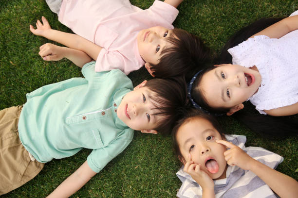 istock The happy children were playing on the grass 1211789195