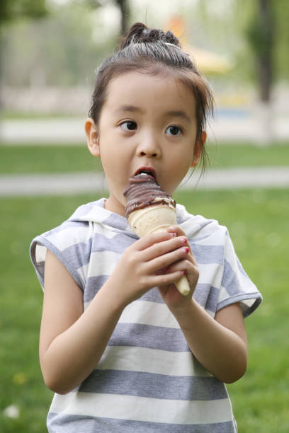 istock The little girl eats ice cream 1211789249