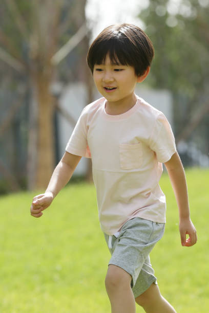 istock The little boy played on the grass 1211789275