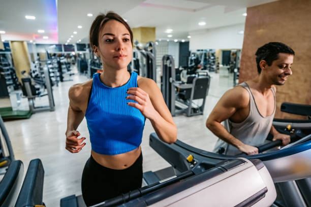 istock Woman running on treadmill in gym 1211789328