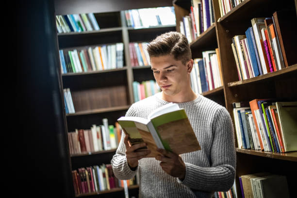 istock Student in the library searches for literature 1211789418