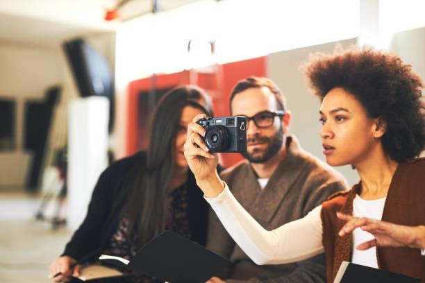 istock Multicultural group of attendees sitting in studio and taking photos on photography class. 1211789446