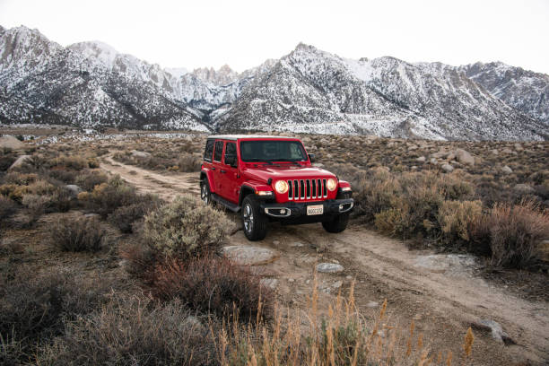 New 2019 Jeep Wrangler at the Alabama Hills Lone Pine, California, United States - March 9, 2019: Photo of a Jeep Wrangler Sahara 2019 edition parked on a dirt road at the Alabama Hills close to the city of Lone Pine. It is the new wild offroad vehicle by Jeep. Headlights are on since the pic has been taken after the sunset. jeep off road stock pictures, royalty-free photos & images