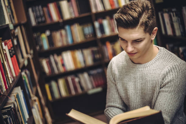 istock Student in the library searches for literature 1211791129