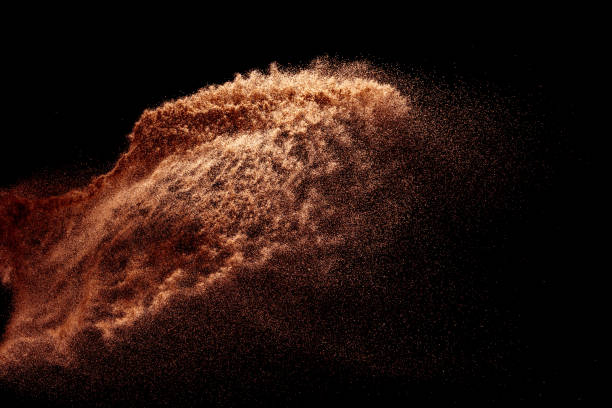 istock Brown colored sand splash.Dry river sand explosion isolated on black background. Abstract sand cloud. 1211792136