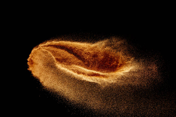 istock Brown colored sand splash.Dry river sand explosion isolated on black background. Abstract sand cloud. 1211792137
