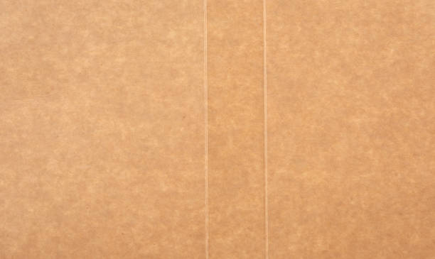 istock piece of smooth brown cardboard paper, full frame 1211792787
