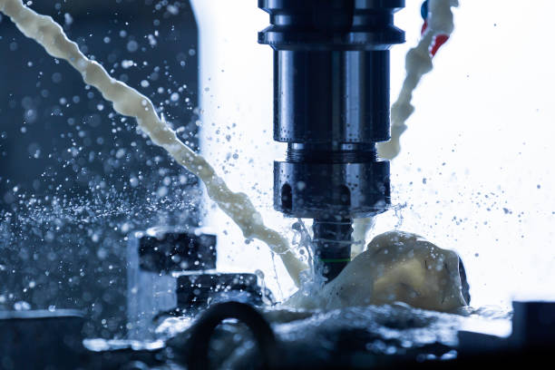 istock a process of vertical cnc steel milling with external water coolant streams, splashes and a lot of metal chips, high contrast, shallow depth of field. 1211793447