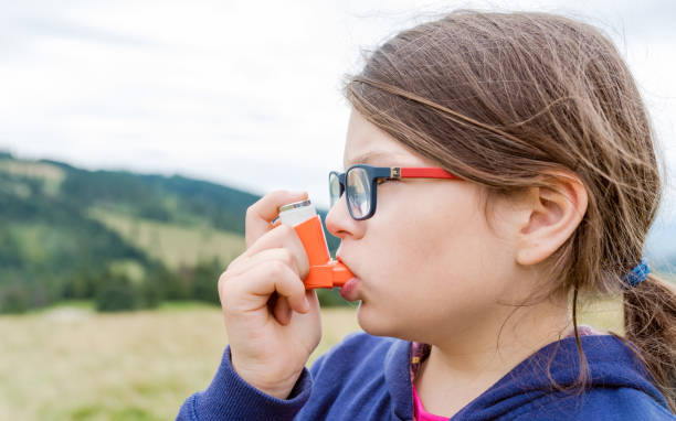 istock Girl having asthma using asthma inhaler for being healthy 1211797163