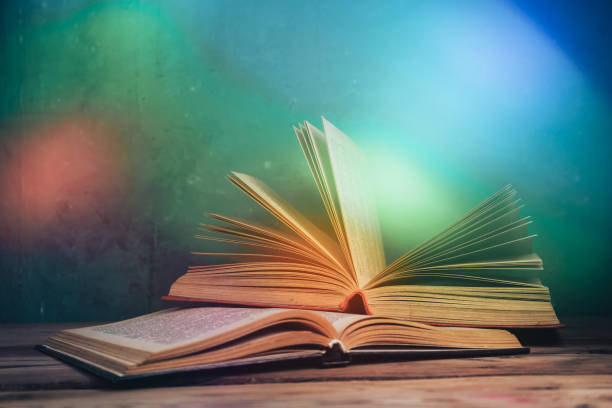 istock Beautiful vintage ancient book. Pattern background for design. The book on a  black glass table  background. 1211797341
