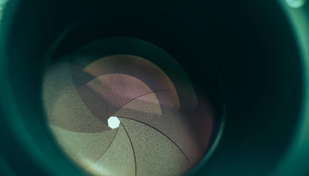 istock Beautiful camera lens with aquamarine  light of glass. Background pattern for design. 1211798225