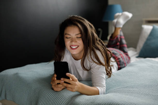 istock Young woman enjoying time at home and using smart phone 1211800450