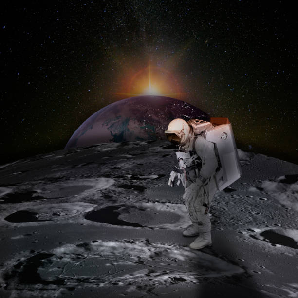 istock Astronaut on moon surface with space background. Planet Earth rises above the surface of the Moon, dotted with craters, and the sunlight behind.  Elements of this image furnished by NASA. 1211800629
