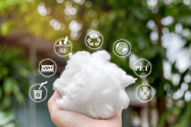 Hand holding Polyester stable fiber Hand holding Polyester stable fiber with green background,recycle icon,picking up&wash Plastic Bottle,Protect the earth icon,PET icon&Yarn icon.Chemical concept polyester photos stock pictures, royalty-free photos & images