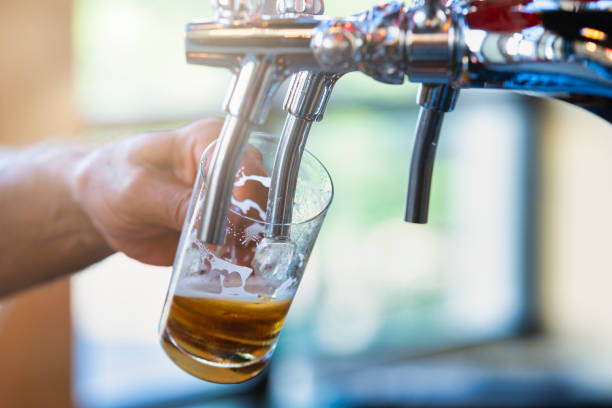 istock Filling crystal glass of beer for tasting 1211802575