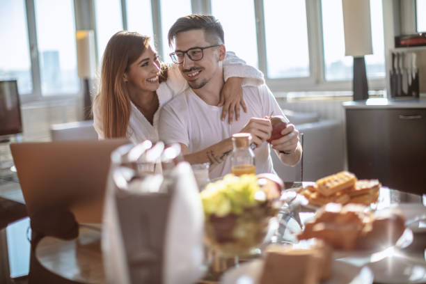 istock Love couple having breakfast at home 1211802736