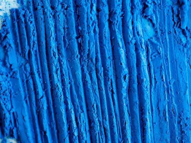 Blue pigment background. Abstract background. Grooves. Paint material