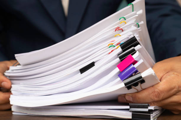istock Male office workers holding documents on office desk, Stack of business paper. 1211804637