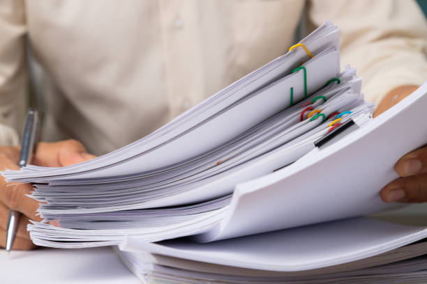 istock Male office workers holding documents on office desk, Stack of business paper. 1211804655