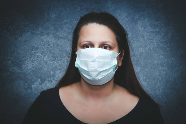 surgical protection mask on woman's face - nurse hygiene emotional stress surgeon imagens e fotografias de stock