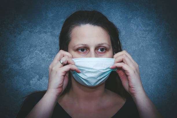 surgical protection mask on woman's face - nurse hygiene emotional stress surgeon imagens e fotografias de stock