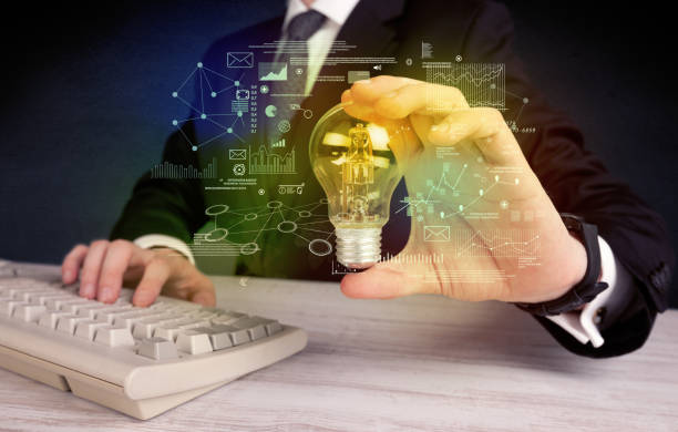 istock businessman holding glowing glass light bulb 1211807416