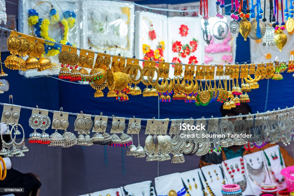 A collection of colorful Indian earrings. A collection of traditional colorful Indian earrings are displayed for selling in handicraft fair. Artificial Stock Photo