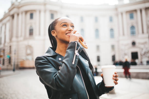 istock Woman with biscuit and coffee 1211808772