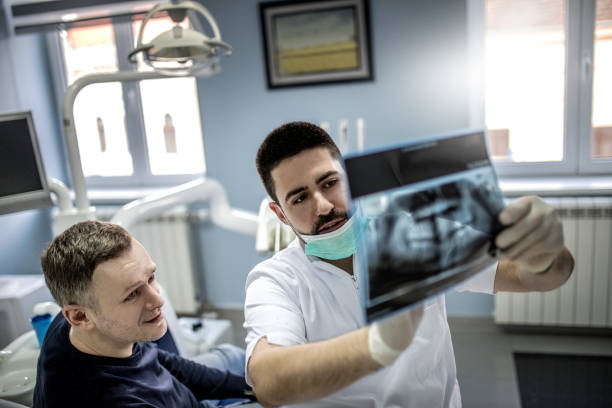 istock man with during examination in dental clinic 1211809331